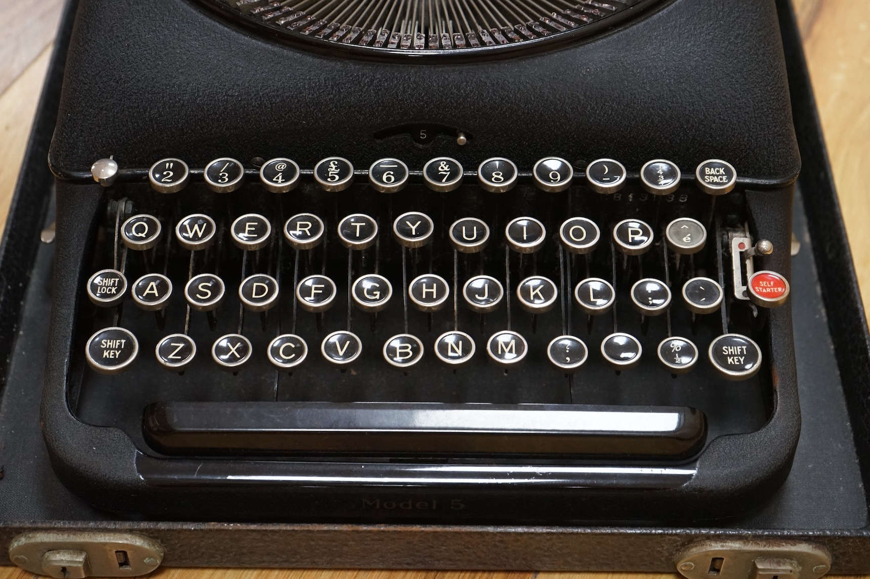 A cased portable Smith Premier Model 5 typewriter, with original guarantee sales label to the inside of the lid dated 22 January 1946.
